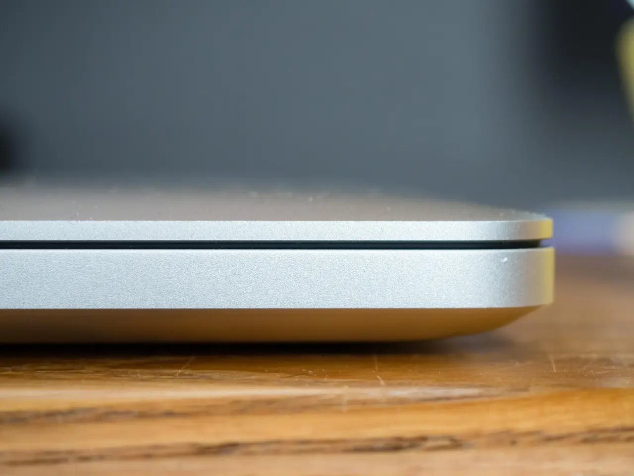 A closed plain laptop seen from the side on a tidy desk